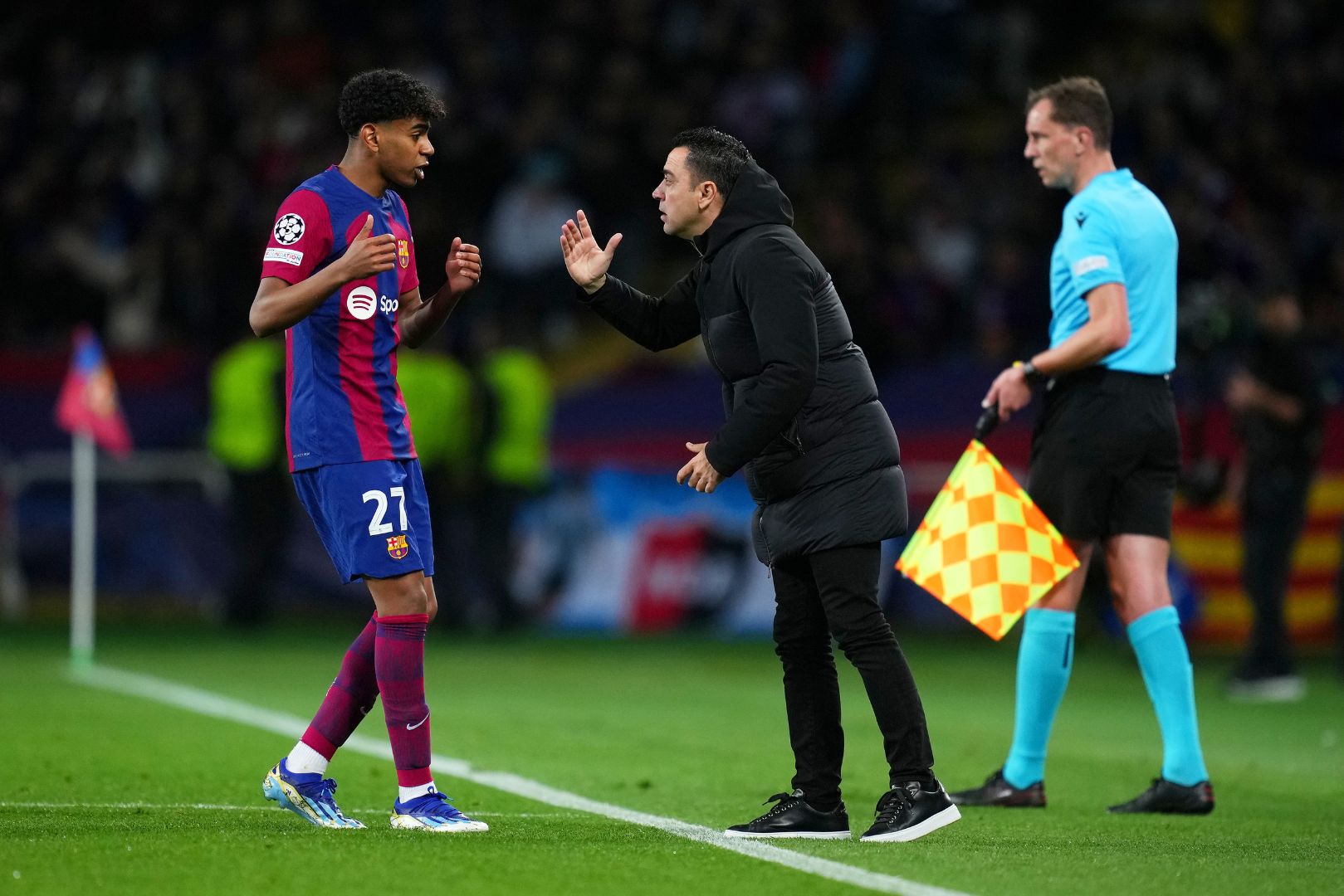 BARCELONA, SPAIN - MARCH 12: Lamine Yamal of FC Barcelona speaks with Xavi, Head Coach of FC Barcelona, during the UEFA Champions League 2023/24 round of 16 second leg match between FC Barcelona and SSC Napoli at Estadi Olimpic Lluis Companys on March 12, 2024 in Barcelona, Spain.