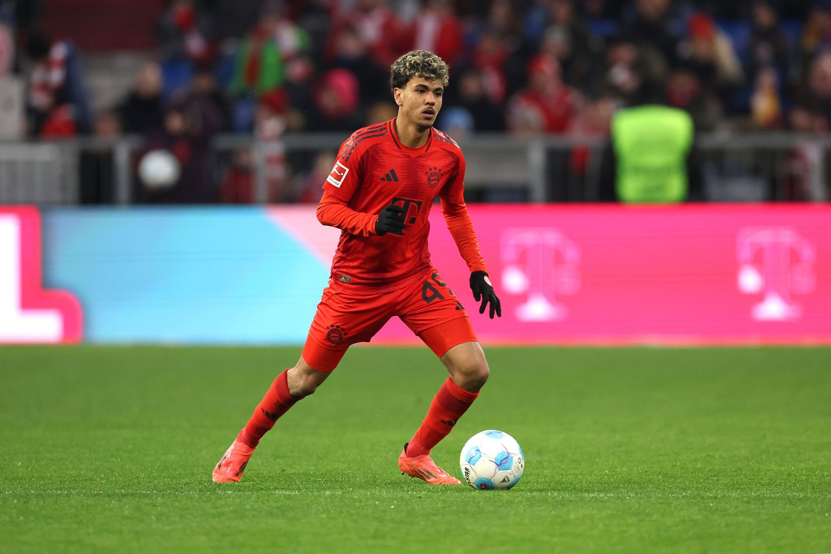 MUNICH, GERMANY - FEBRUARY 01: Adam Aznou of FC Bayern München runs with the ball during the Bundesliga match between FC Bayern München and Holstein Kiel at Allianz Arena on February 01, 2025 in Munich, Germany.