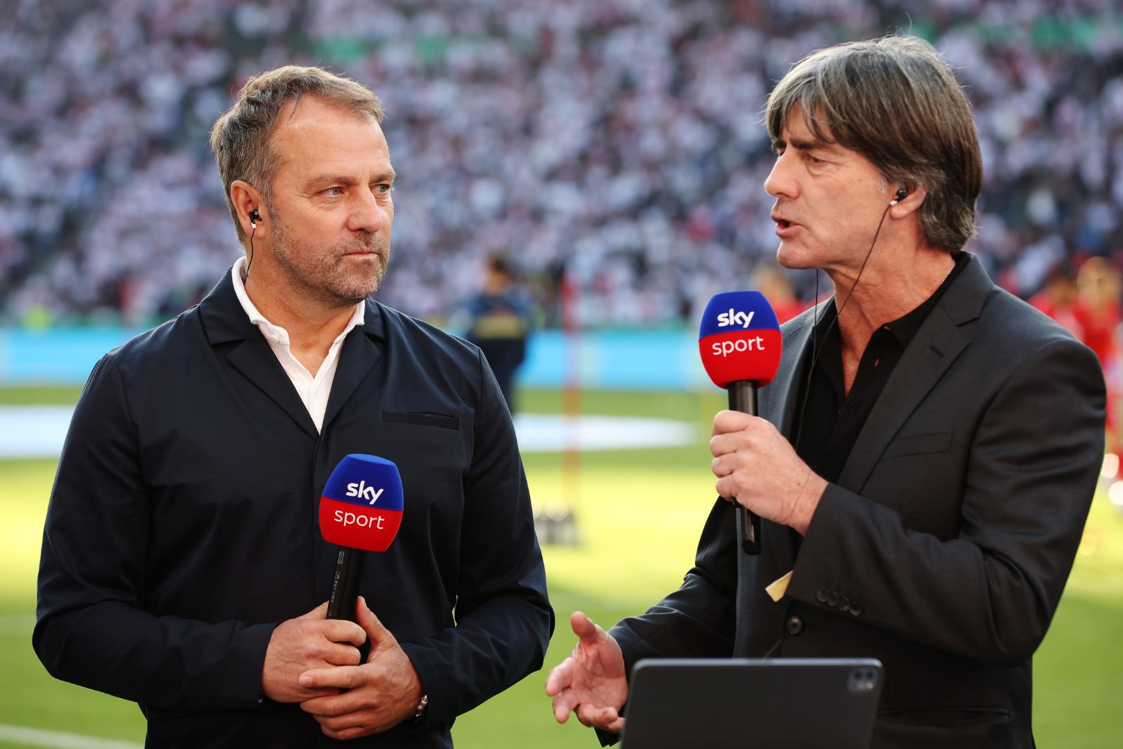 BERLIN, GERMANY - MAY 21: Germany National Team head coach, Hansi Flick speaks with Joachim Loew (R), former Germany National Team head coach prior to the final match of the DFB Cup 2022 between SC Freiburg and RB Leipzig at Olympiastadion on May 21, 2022 in Berlin, Germany.