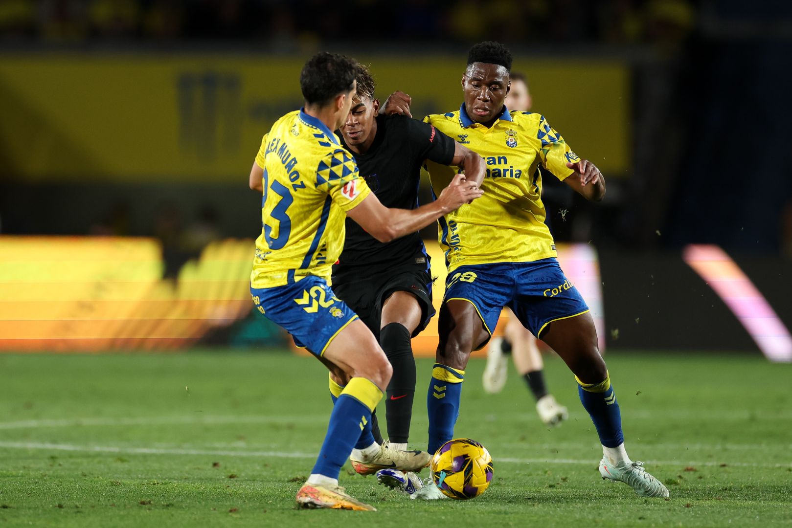 LAS PALMAS, SPAIN - FEBRUARY 22: Lamine Yamal of FC Barcelona is challenged by Alex Munoz and Dario Essugo of UD Las Palmas during the LaLiga match between UD Las Palmas and FC Barcelona at Estadio Gran Canaria on February 22, 2025 in Las Palmas, Spain.