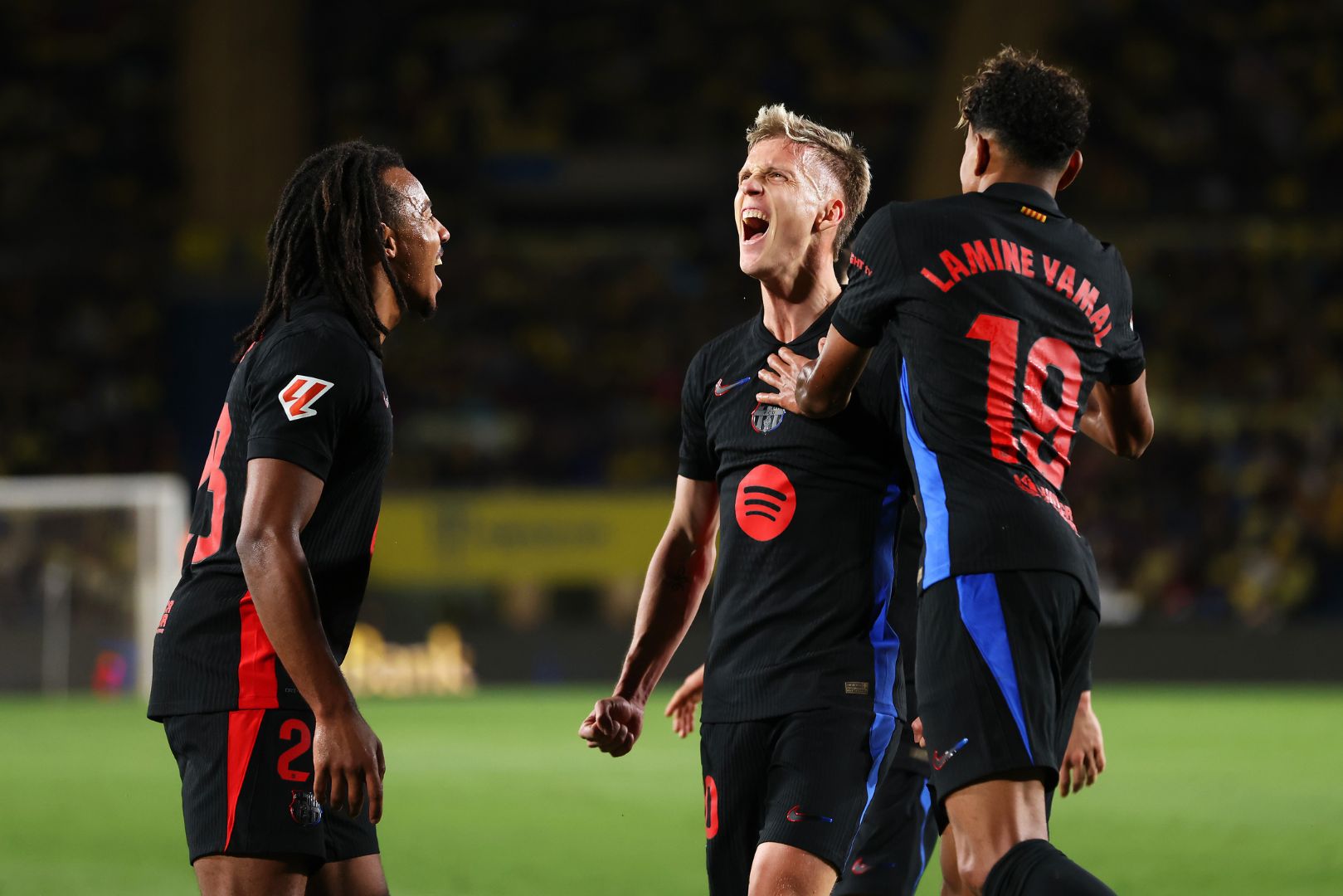 LAS PALMAS, SPAIN - FEBRUARY 22: Dani Olmo of FC Barcelona celebrates with his team mates Jules Kounde and Lamine Yamal after scoring his team's first goal during the LaLiga match between UD Las Palmas and FC Barcelona at Estadio Gran Canaria on February 22, 2025 in Las Palmas, Spain.
