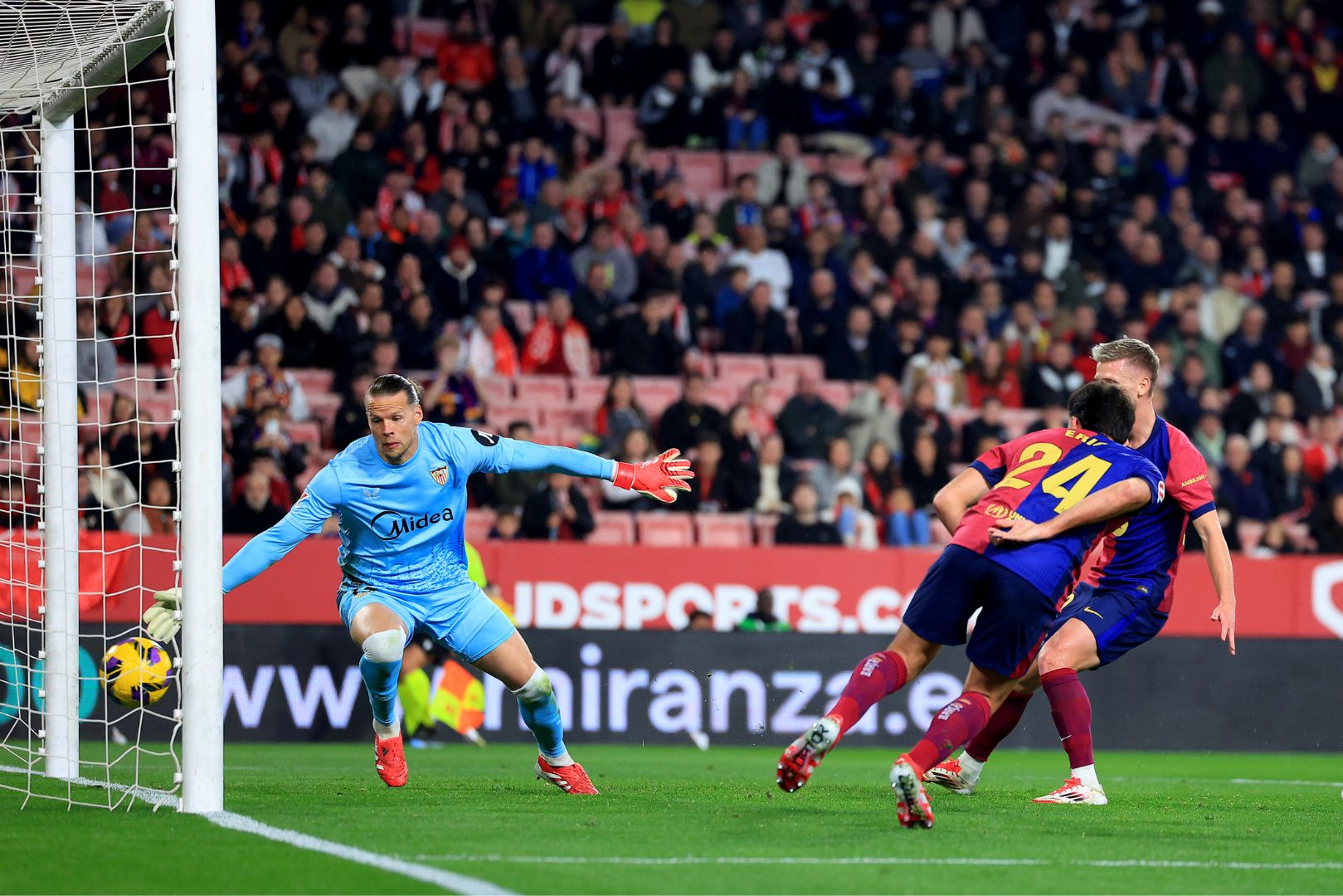 SEVILLE, SPAIN - FEBRUARY 09: Eric Garcia of FC Barcelona scores his team's fourth goal with a header as Oerjan Nyland of Sevilla FC fails to make a save during the LaLiga match between Sevilla FC and FC Barcelona at Estadio Ramon Sanchez Pizjuan on February 09, 2025 in Seville, Spain.
