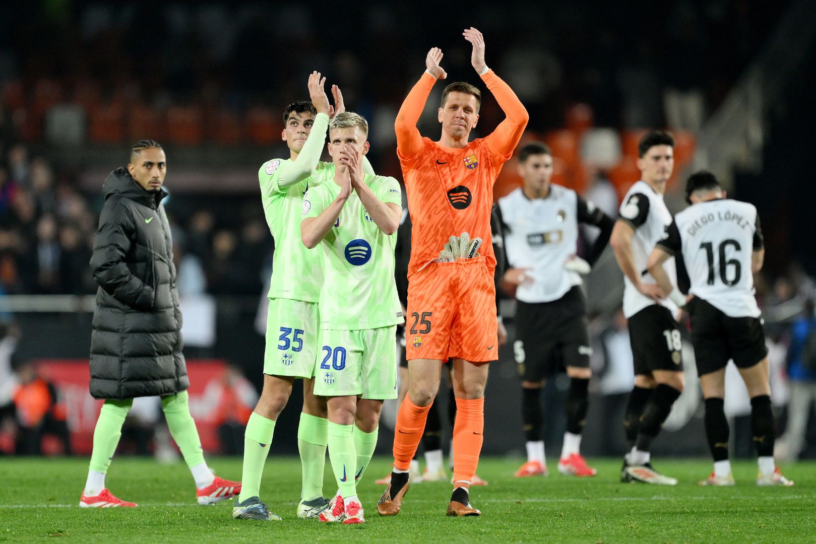 VALENCIA, SPAIN - FEBRUARY 06: Gerard Martin, Dani Olmo and Wojciech Szczesny of FC Barcelona applaud the fans at full-time following the team's victory in the Copa del Rey quarter-final match between Valencia CF and FC Barcelona at the Estadio Mestalla on February 06, 2025 in Valencia, Spain.