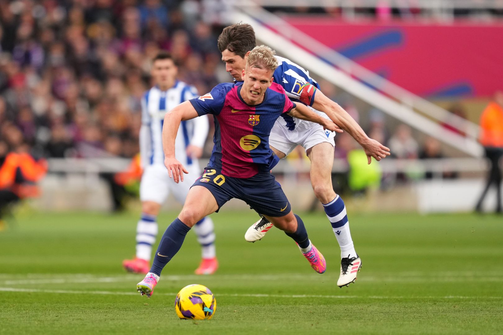 BARCELONA, SPAIN - MARCH 02: Aritz Elustondo of Real Sociedad fouls Dani Olmo of FC Barcelona leading to him being shown a red card during the La Liga EA match between FC Barcelona and Real Sociedad at Estadi Olimpic Lluis Companys on March 02, 2025 in Barcelona, Spain.