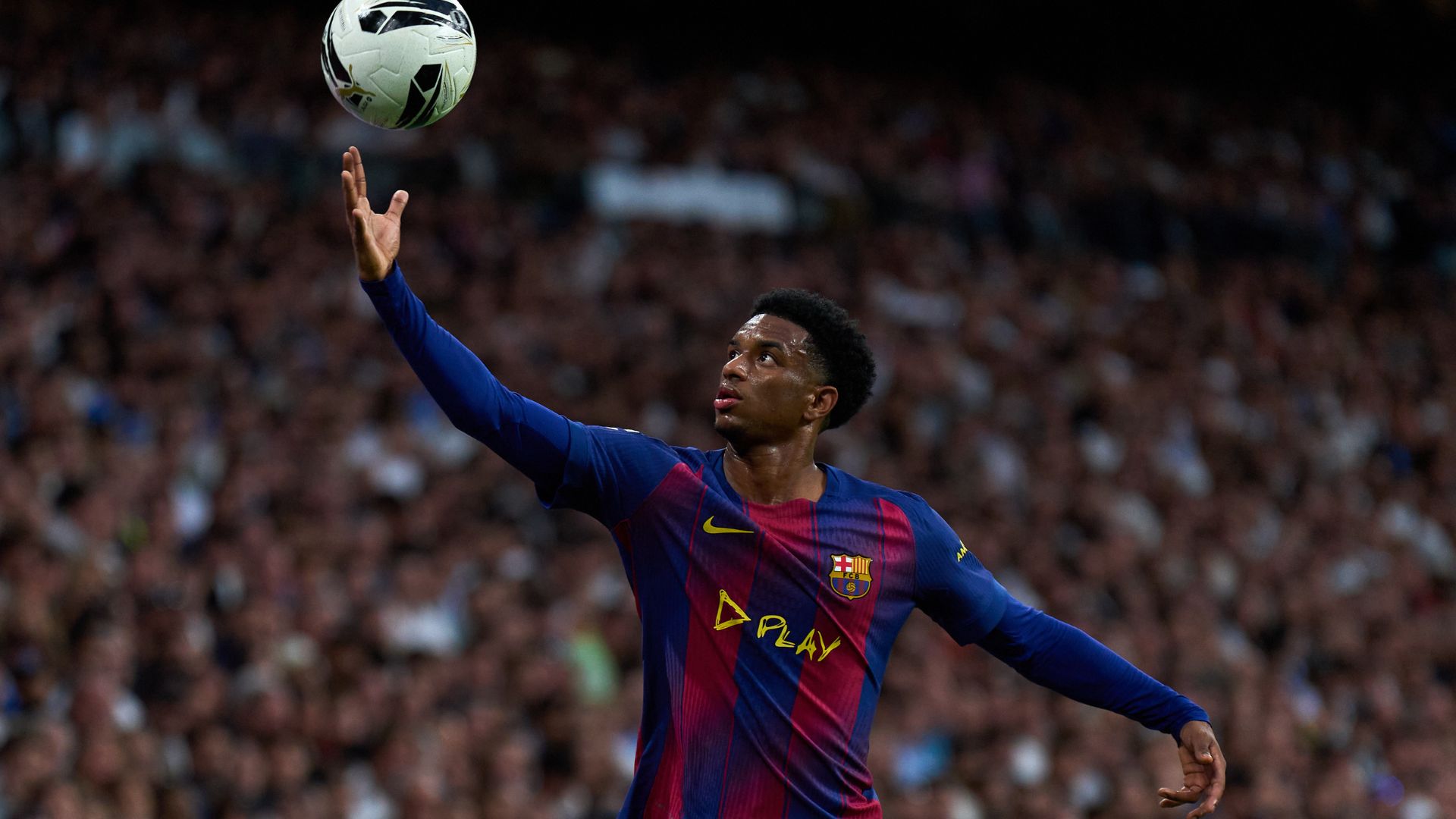 Alejandro Balde of FC Barcelona controls the ball during the LaLiga EA Sports match between Real Madrid CF and FC Barcelona at Estadio Santiago Bernabeu on October 26, 2025 in Madrid, Spain.
