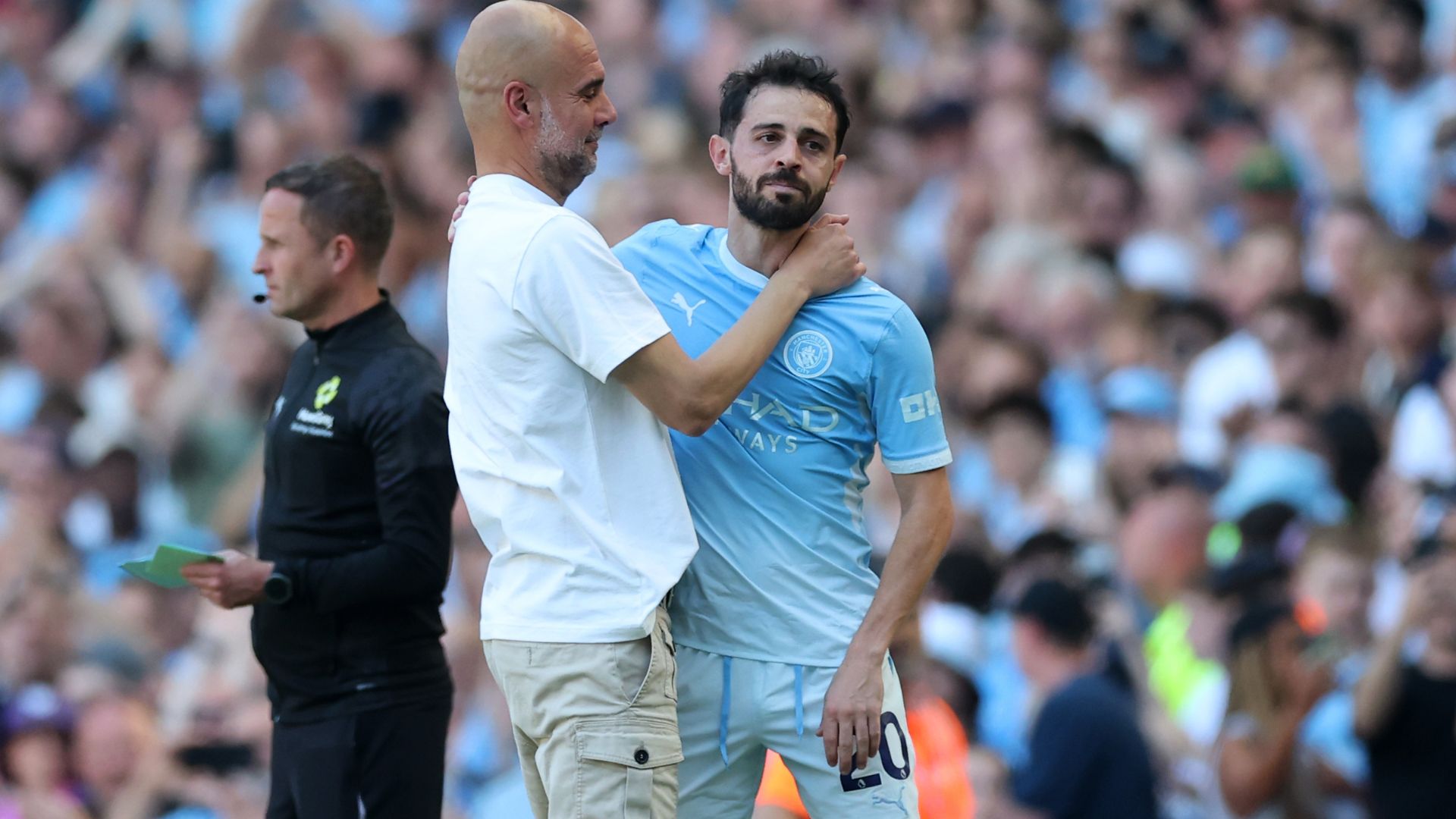 MANCHESTER, ENGLAND - MAY 24: Pep Guardiola, Manager of Manchester City, embraces Bernardo Silva as he leaves the pitch whilst being substituted during the Premier League match between Manchester City and Aston Villa at the Etihad Stadium on May 24, 2026 in Manchester, England.