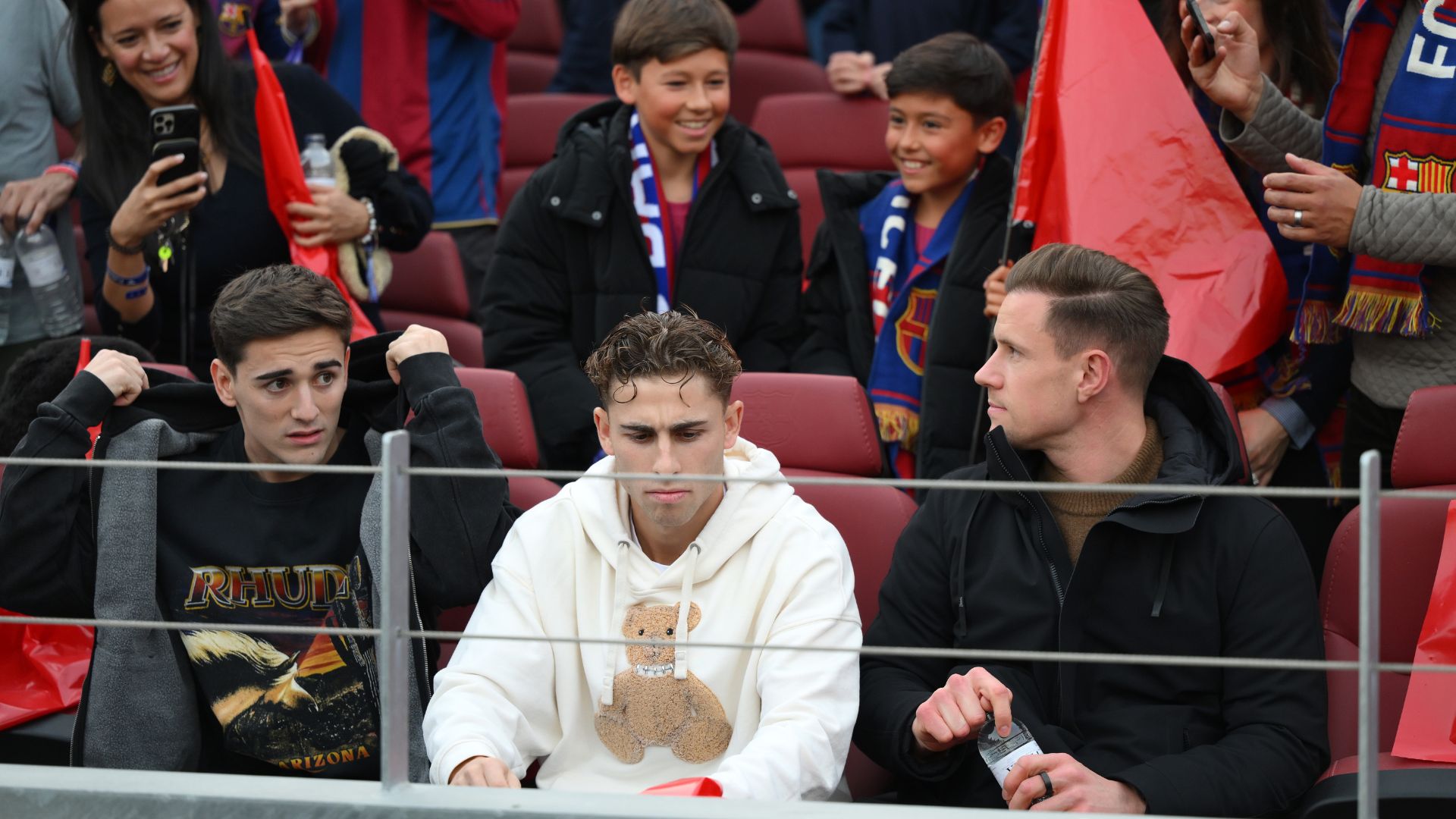 Gavi, Fermin Lopez and Marc-Andre ter Stegen of FC Barcelona show their support from the stands during the LaLiga EA Sports match between FC Barcelona and Deportivo Alaves at Spotify Camp Nou on November 29, 2025 in Barcelona, Spain.