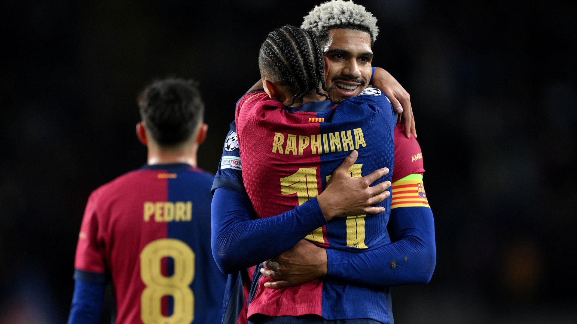 Ronald Araujo of FC Barcelona celebrates scoring his team's second goal with teammate Raphinha during the UEFA Champions League 2024/25 League Phase MD8 match between FC Barcelona and Atalanta BC at Estadi Olimpic Lluis Companys on January 29, 2025 in Barcelona, Spain.