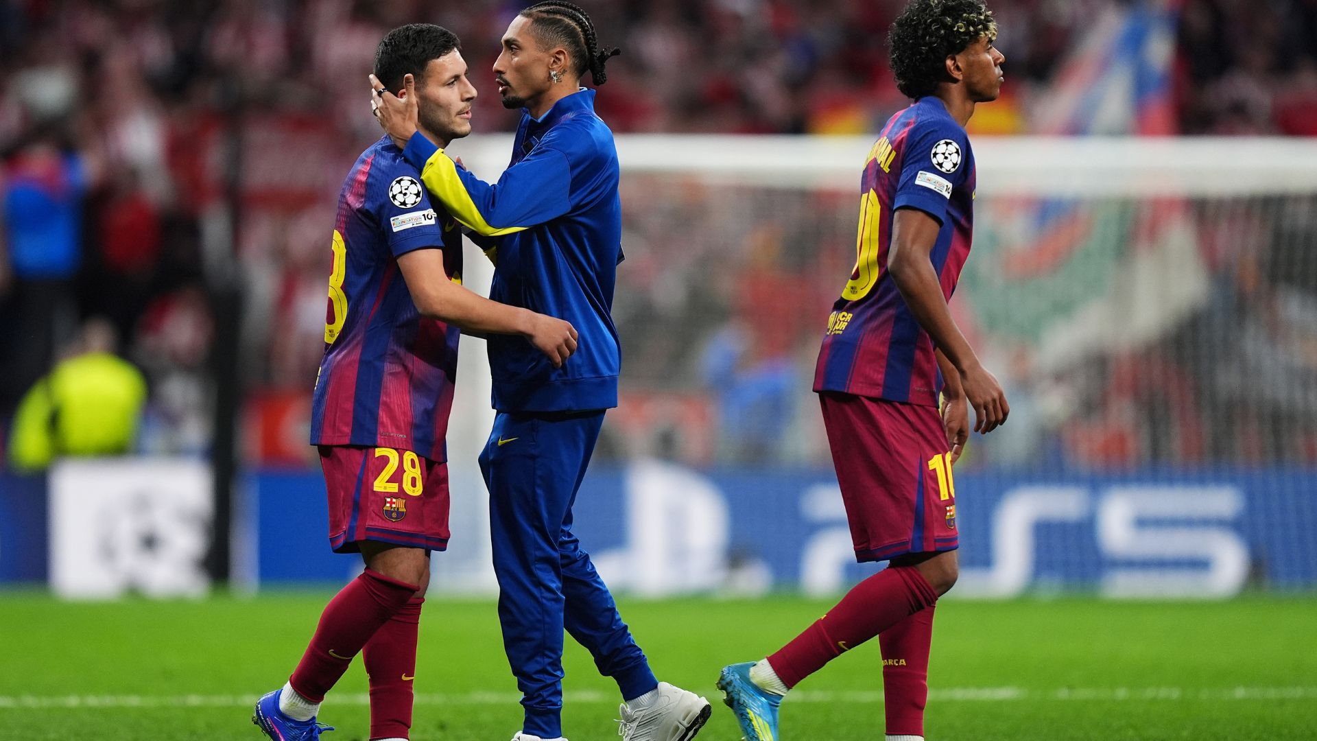 MADRID, SPAIN - APRIL 14: Lamine Yamal and Roony Bardghji of FC Barcelona are consoled by team mate Raphinha following their elimination after the UEFA Champions League 2025/26 Quarter-Final Second Leg match between Club Atlético de Madrid and FC Barcelona at Riyadh Air Metropolitano on April 14, 2026 in Madrid, Spain.