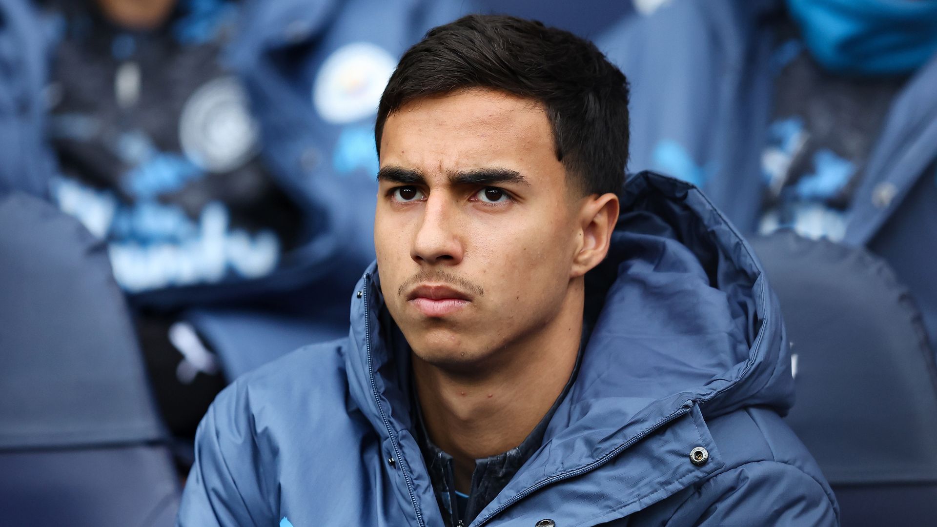 Vitor Reis of Manchester City looks on from the substitutes bench during the Premier League match between Manchester City FC and Brighton & Hove Albion FC at Etihad Stadium on March 15, 2025 in Manchester, England.