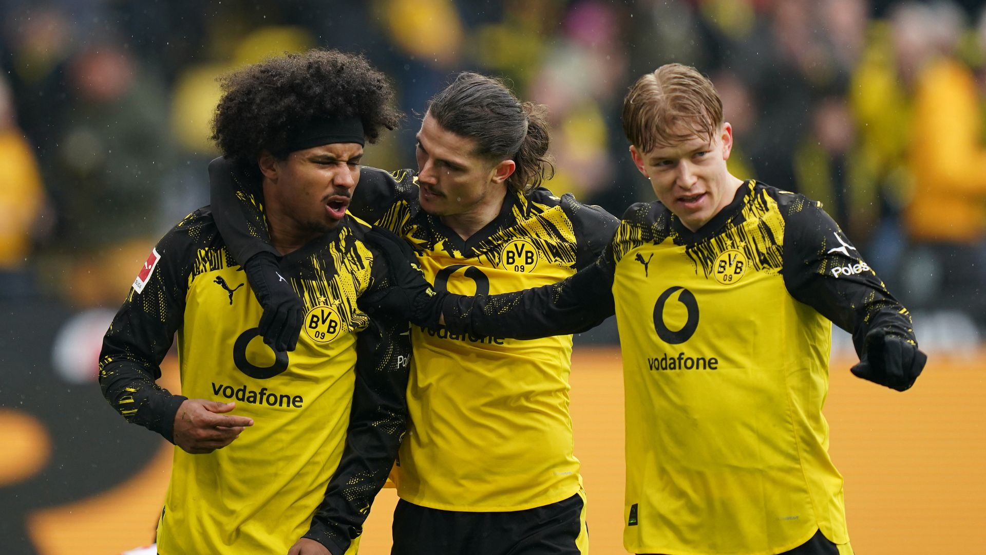 DORTMUND, GERMANY - MARCH 14: Karim Adeyemi of Borussia Dortmund celebrates scoring his team's first goal with teammates Marcel Sabitzer (C) and Daniel Svensson (R) during the Bundesliga match between Borussia Dortmund and FC Augsburg at Signal Iduna Park on March 14, 2026 in Dortmund, Germany.