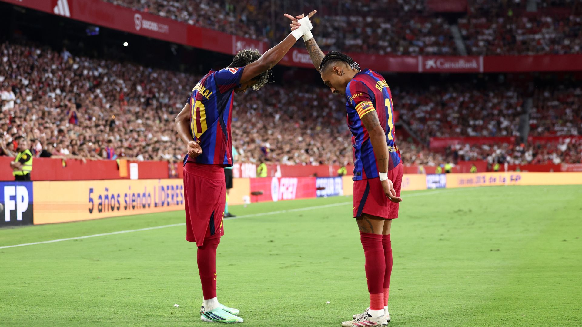 SEVILLE, SPAIN - SEPTEMBER 19: Raphinha of FC Barcelona (R) celebrates with teammate Lamine Yamal after scoring their team’s second goal during the LaLiga EA Sports 2026/27 match between Sevilla FC and FC Barcelona at Estadio Ramon Sanchez Pizjuan on September 19, 2026 in Seville, Spain.